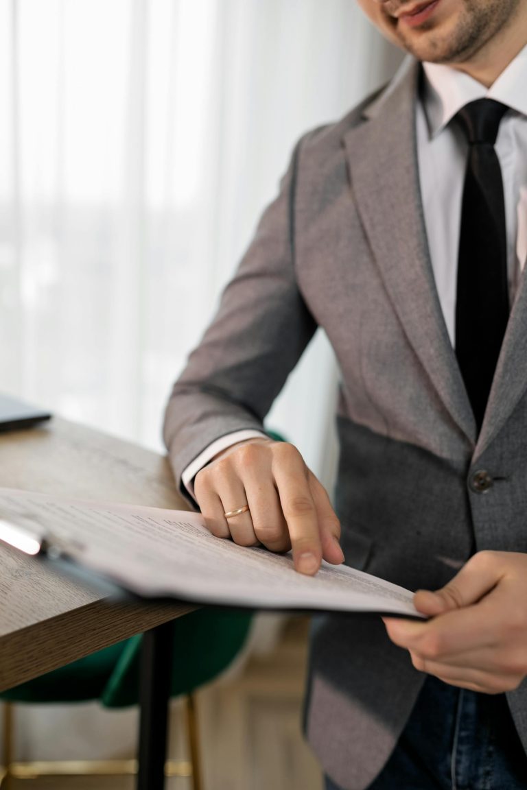 Business professional in suit reviewing important documents at the office.